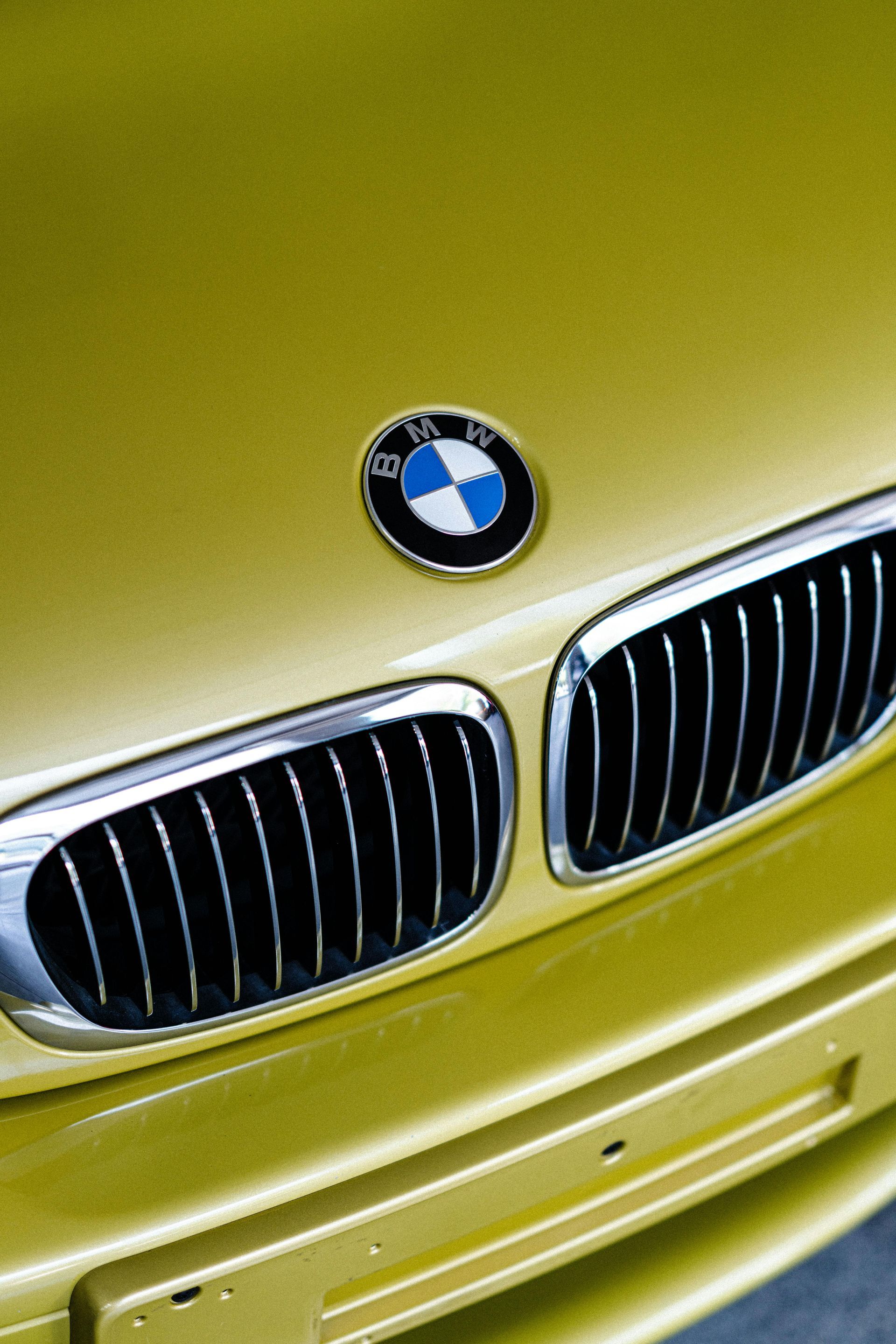 A close up of the front of a yellow bmw