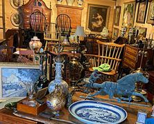 Silverware, small bowls, and a decorative tray arranged on a rustic, dark wooden table.