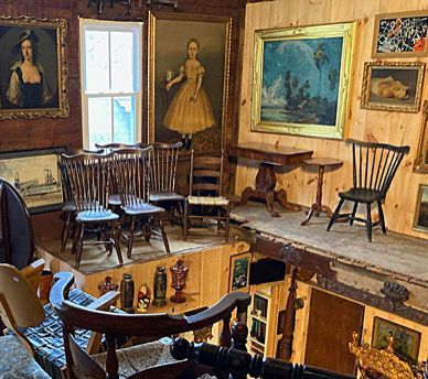 Four paintings of people in a brightly lit art gallery with a bench on a wooden floor.