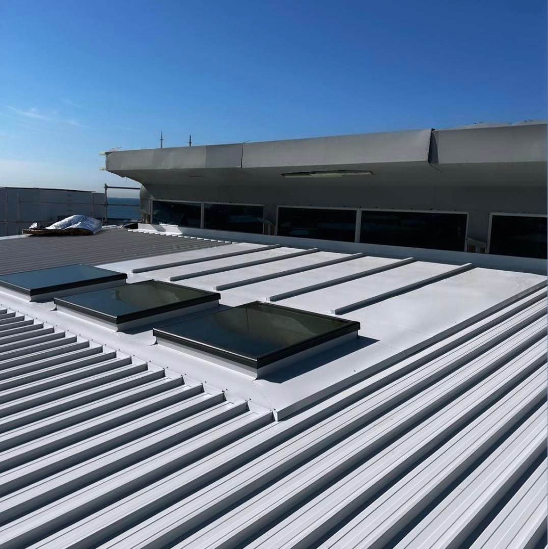 The Roof Of A Building With A Blue Sky In The Background — Kimick Roofing Solutions In Wyong, NSW