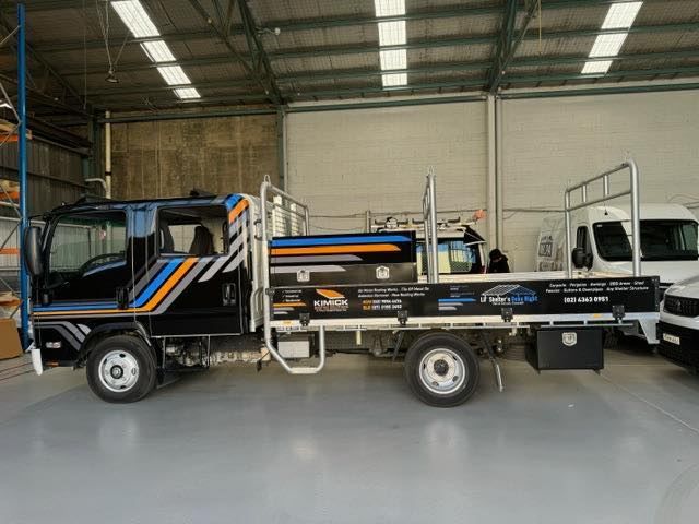 A Truck Is Parked In A Warehouse With Other Trucks — Kimick Roofing Solutions In Wyong, NSW