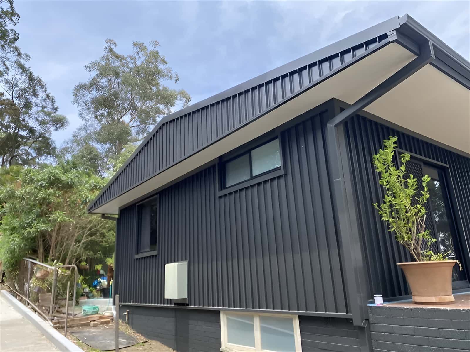 A Black House With A White Roof — Kimick Roofing Solutions In Wyong, NSW