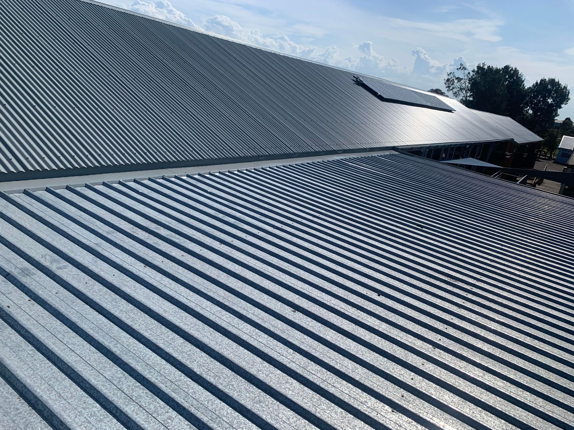 An Aerial View Of A School Roof— Kimick Roofing Solutions In Fortitude Valley, QLD