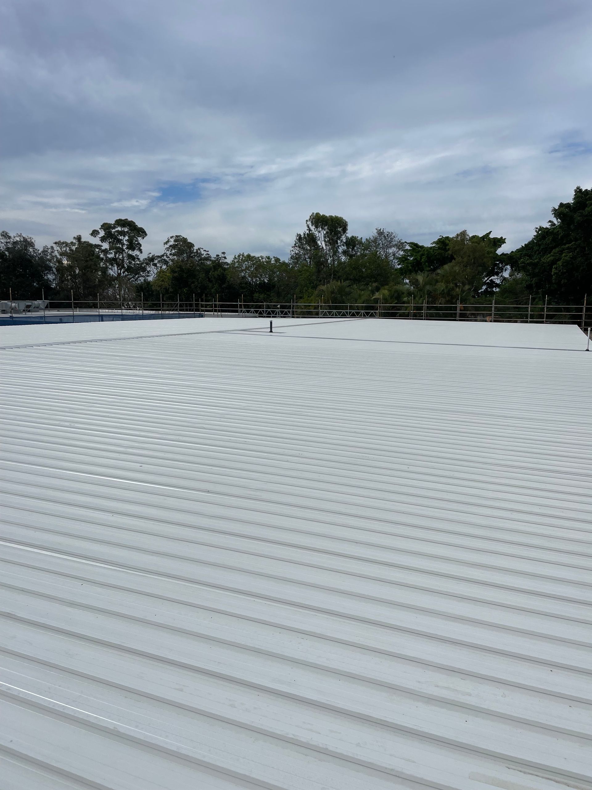 The Roof Of A House Is Being Repaired With Scaffolding — Kimick Roofing Solutions In Wyong, NSW