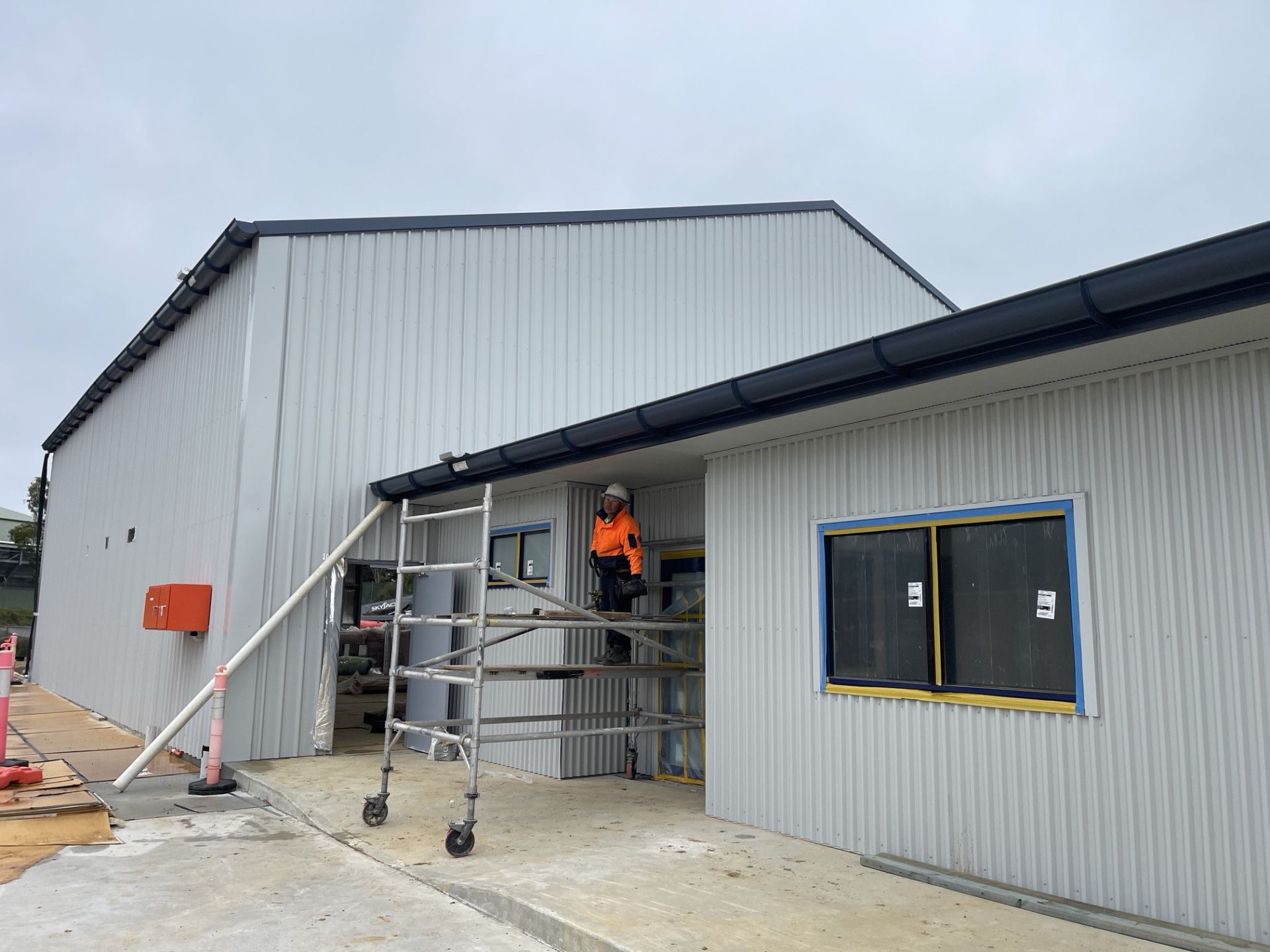 Two Buildings Under Construction And The Dirt Alley Way Between Them — Kimick Roofing Solutions In Blacktown, NSW