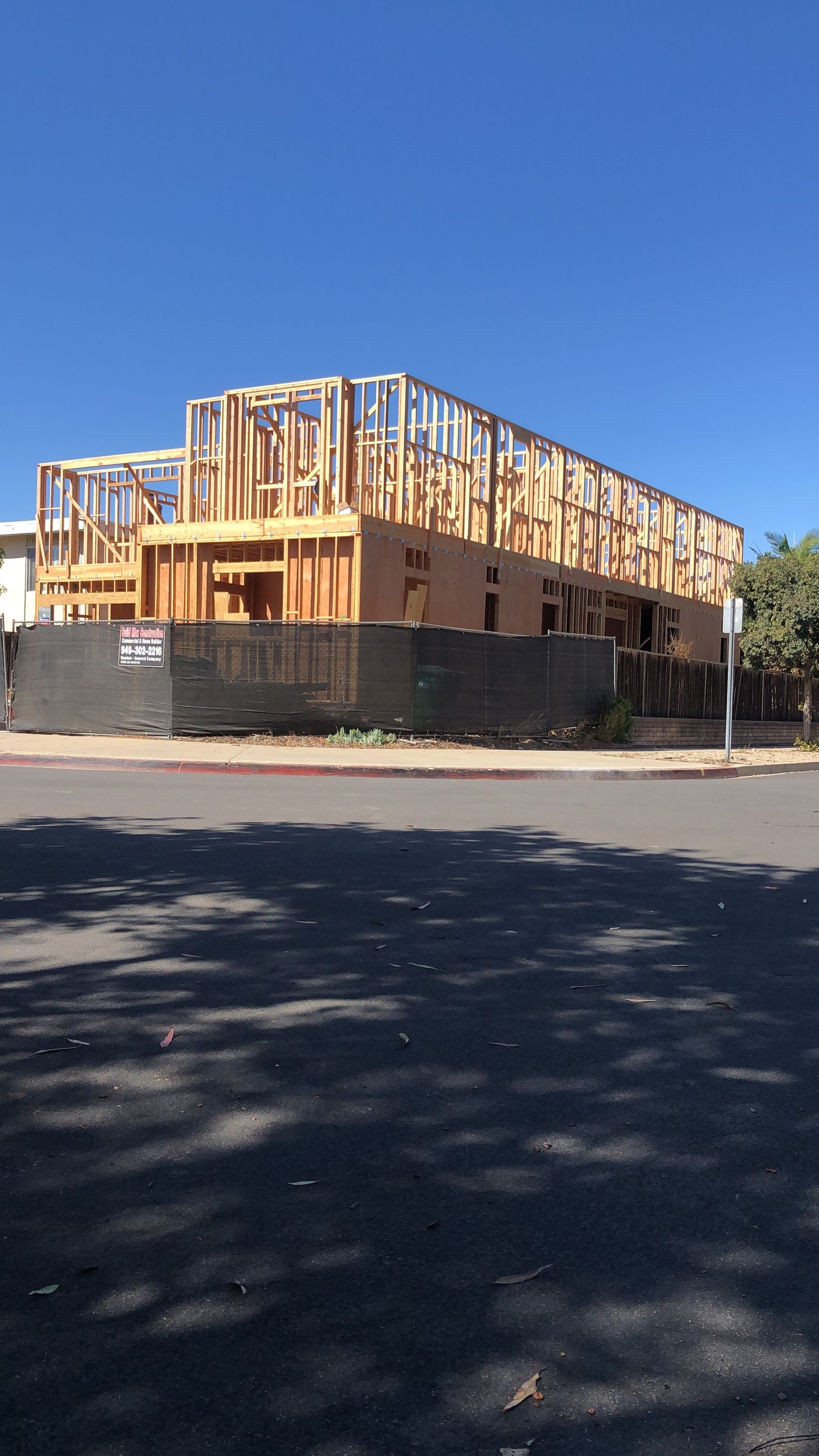 A large building is being built on the side of the road