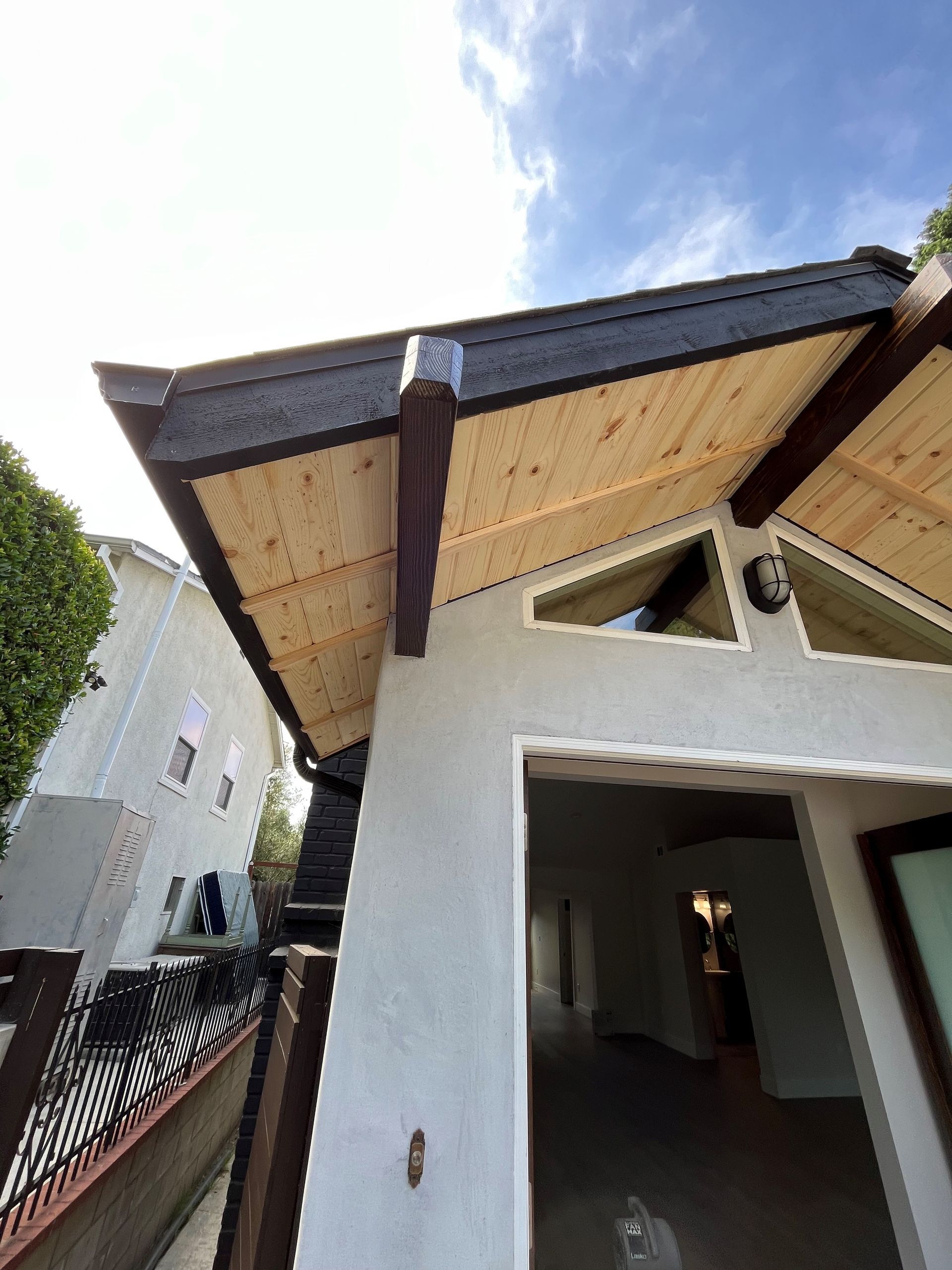Looking up at the roof of a house with a wooden roof
