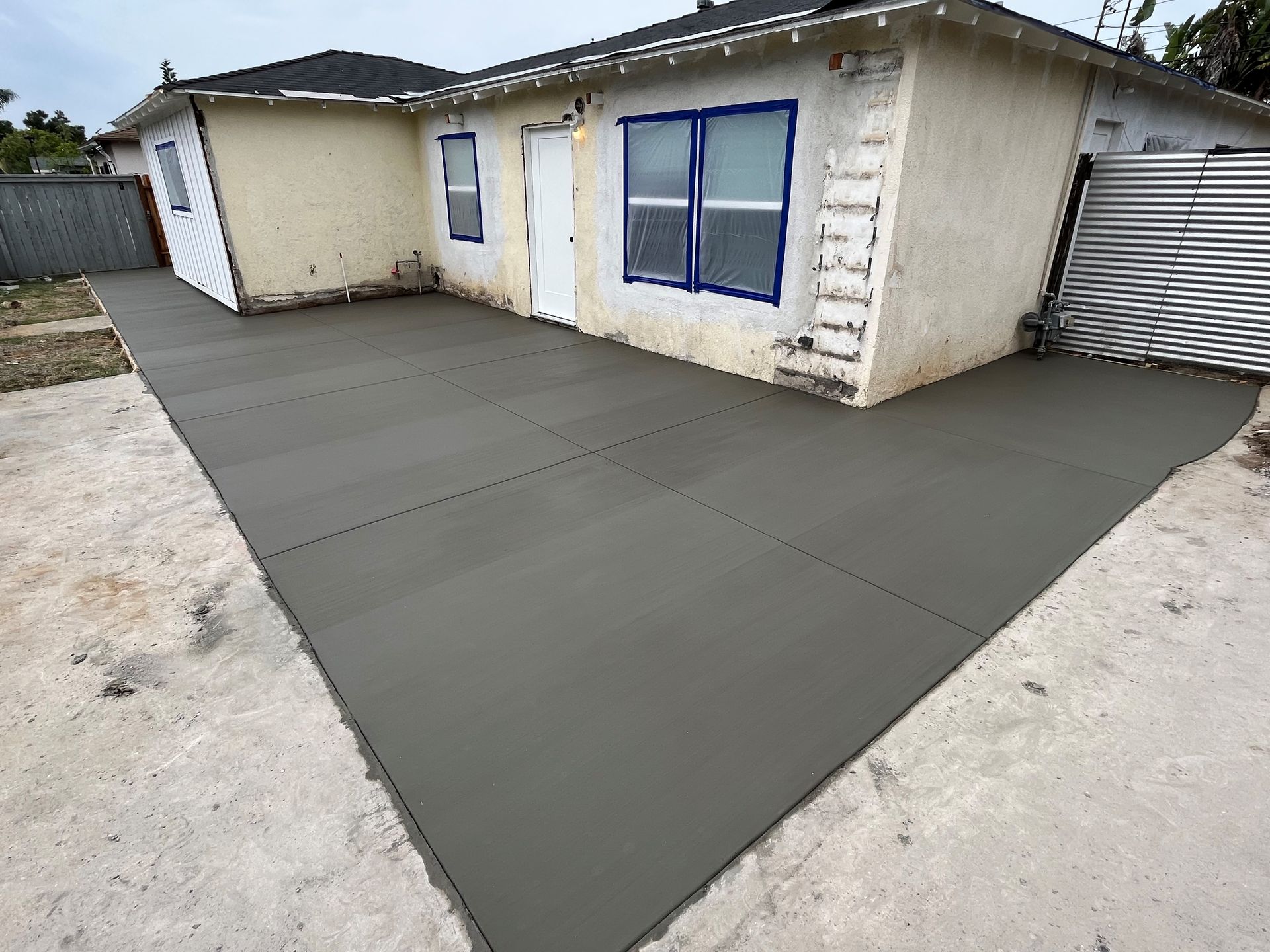 A house with a concrete driveway in front of it