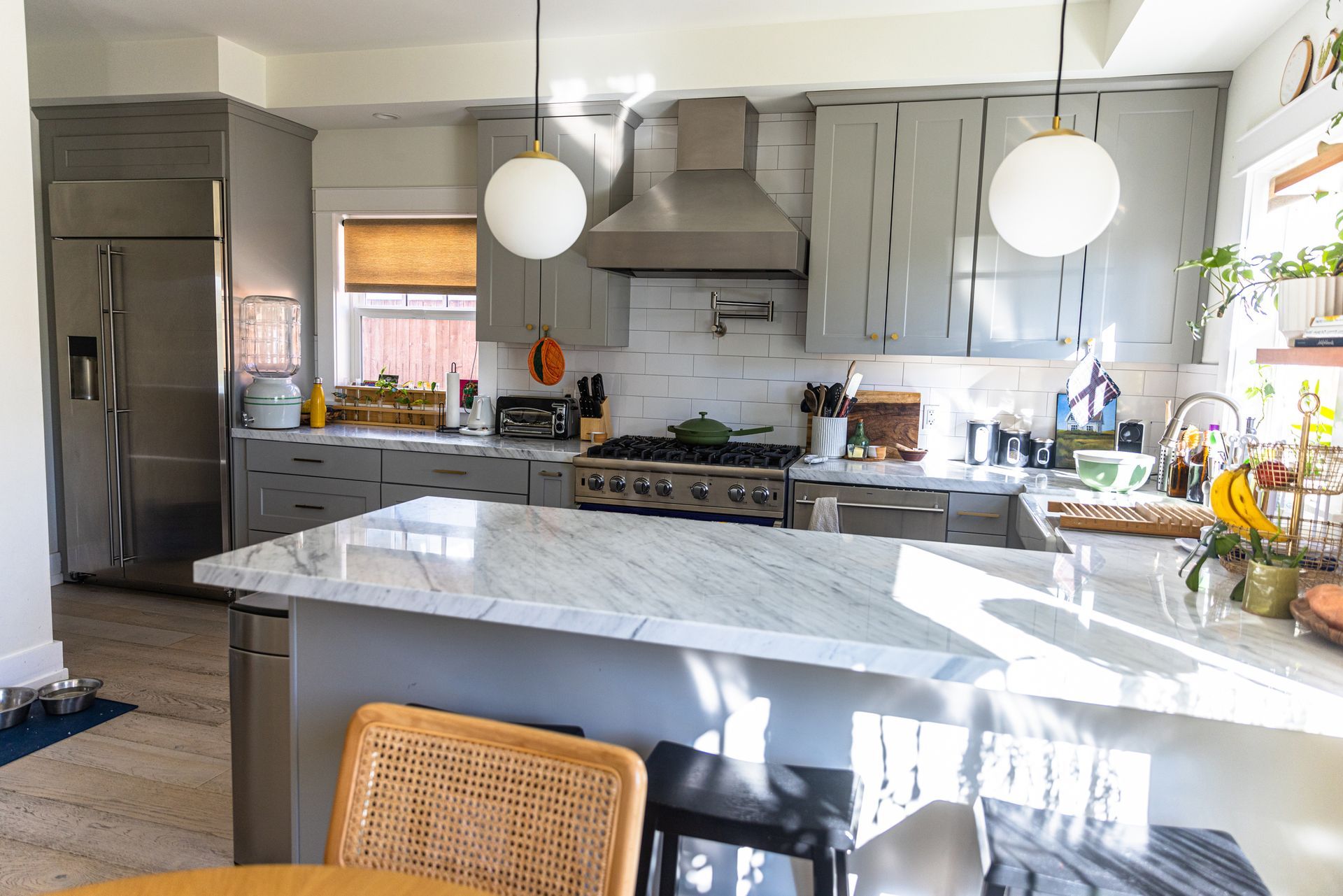 A kitchen with stainless steel appliances and a marble counter top.