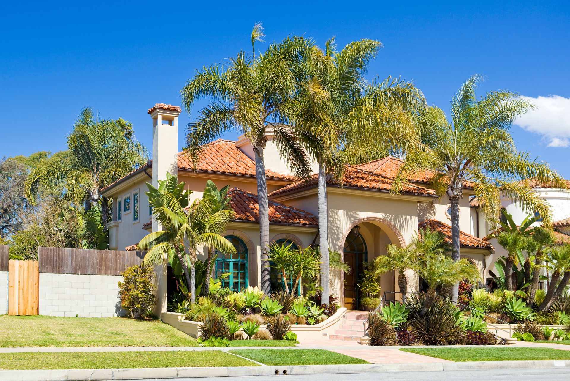 A large house with palm trees in front of it