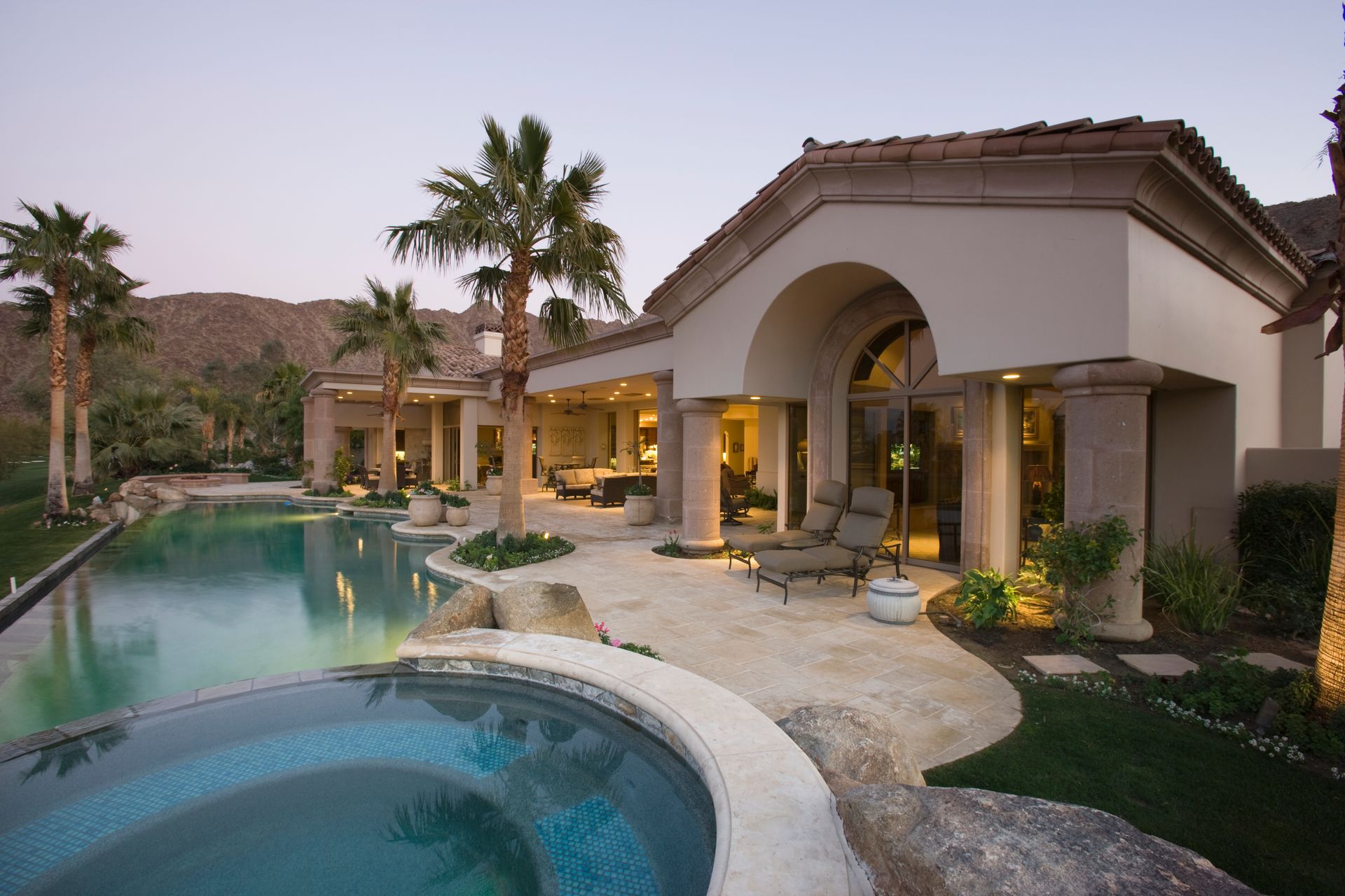 A large house with a swimming pool and a hot tub