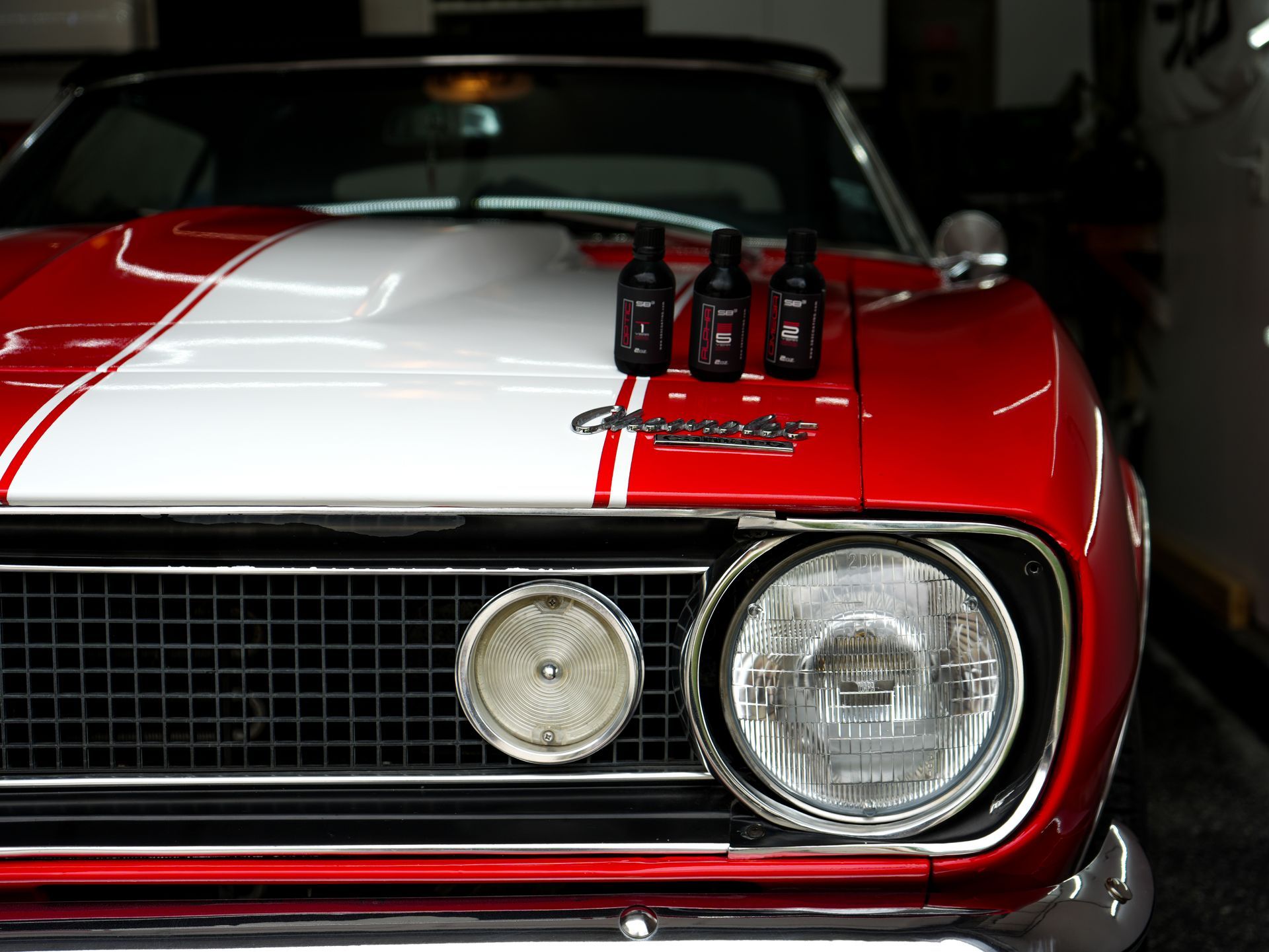a man in a black shirt is polishing a car