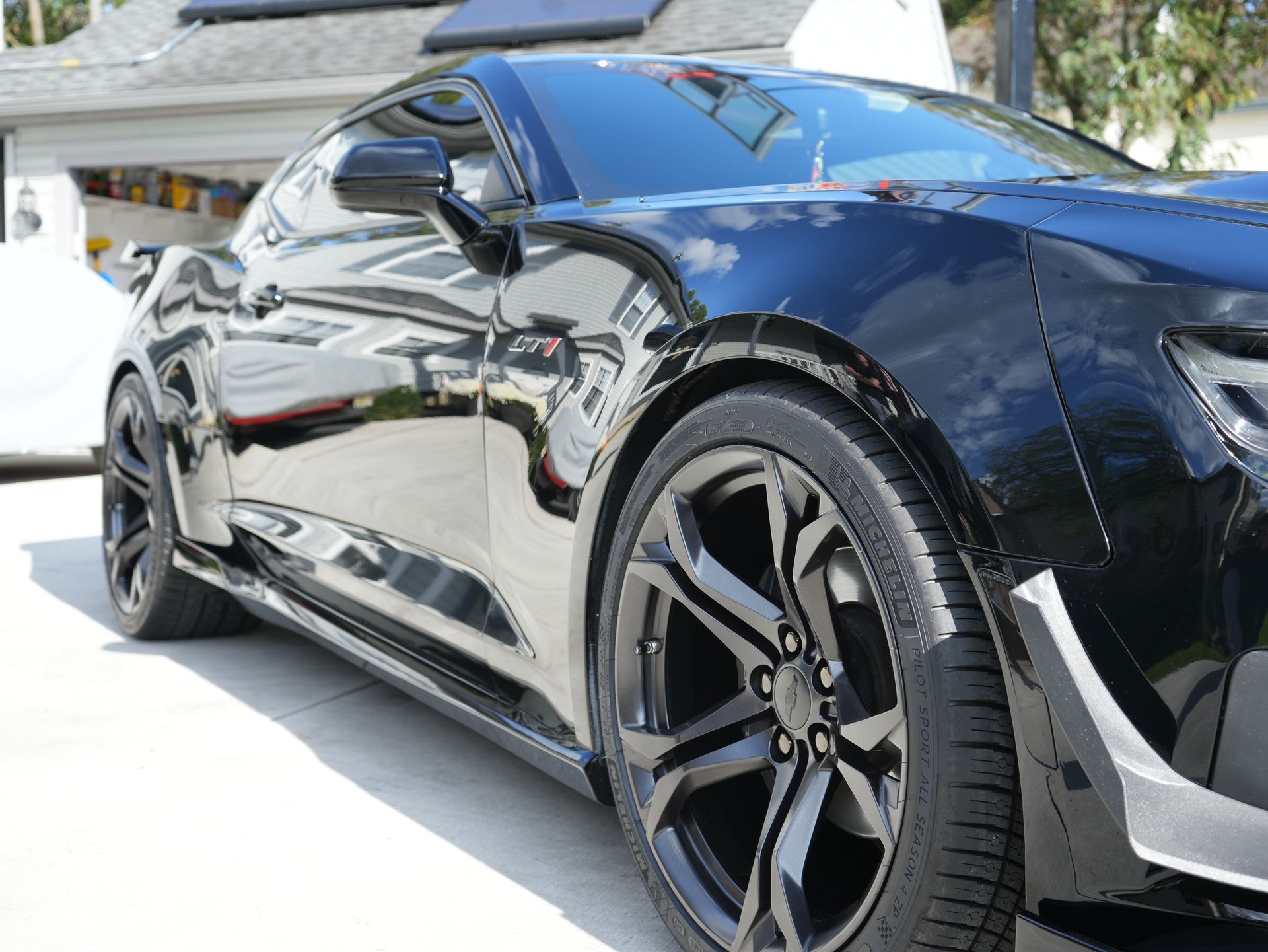 a black car with a tire that says pirelli on it