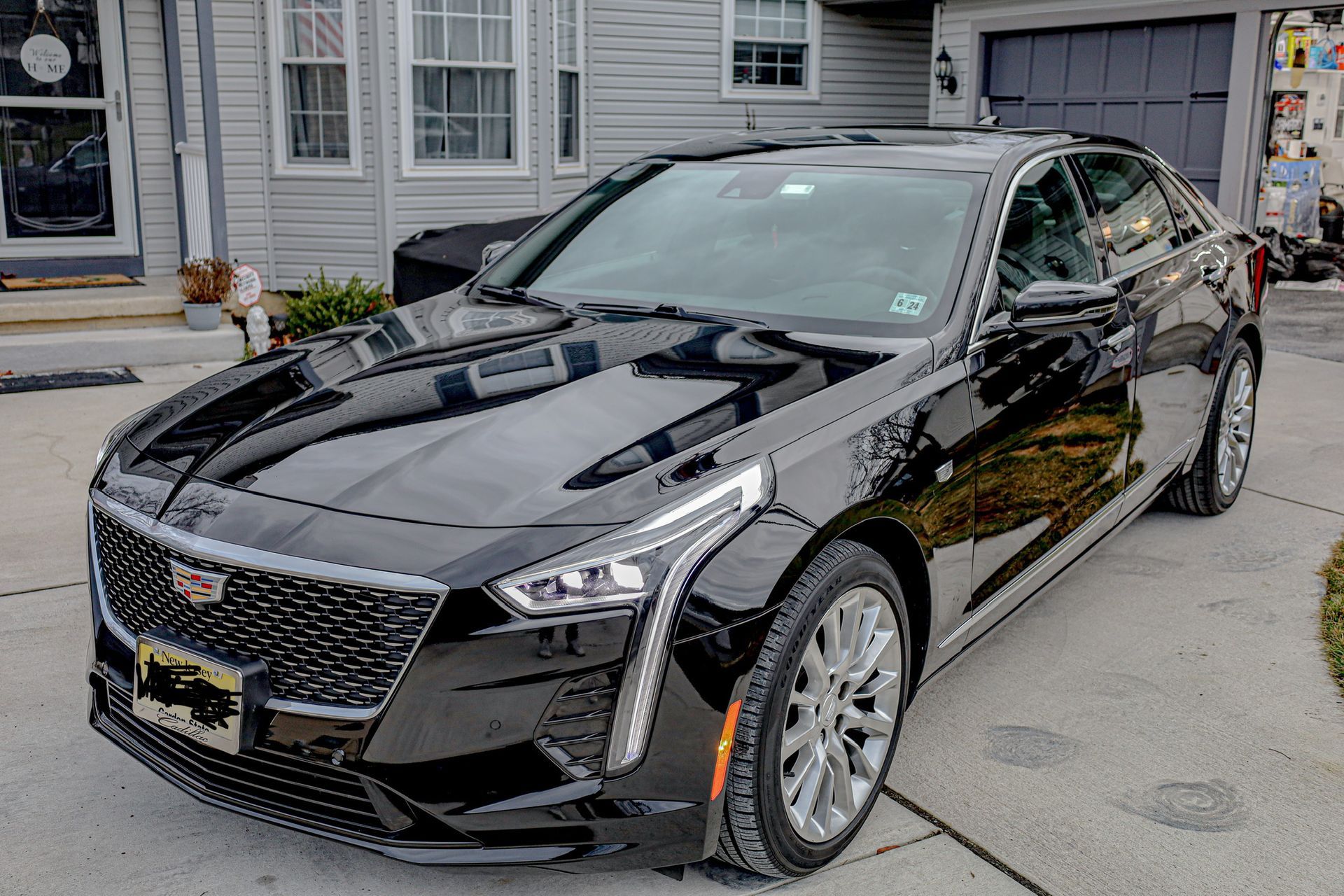 a man wearing a hat with a star on it works on a car