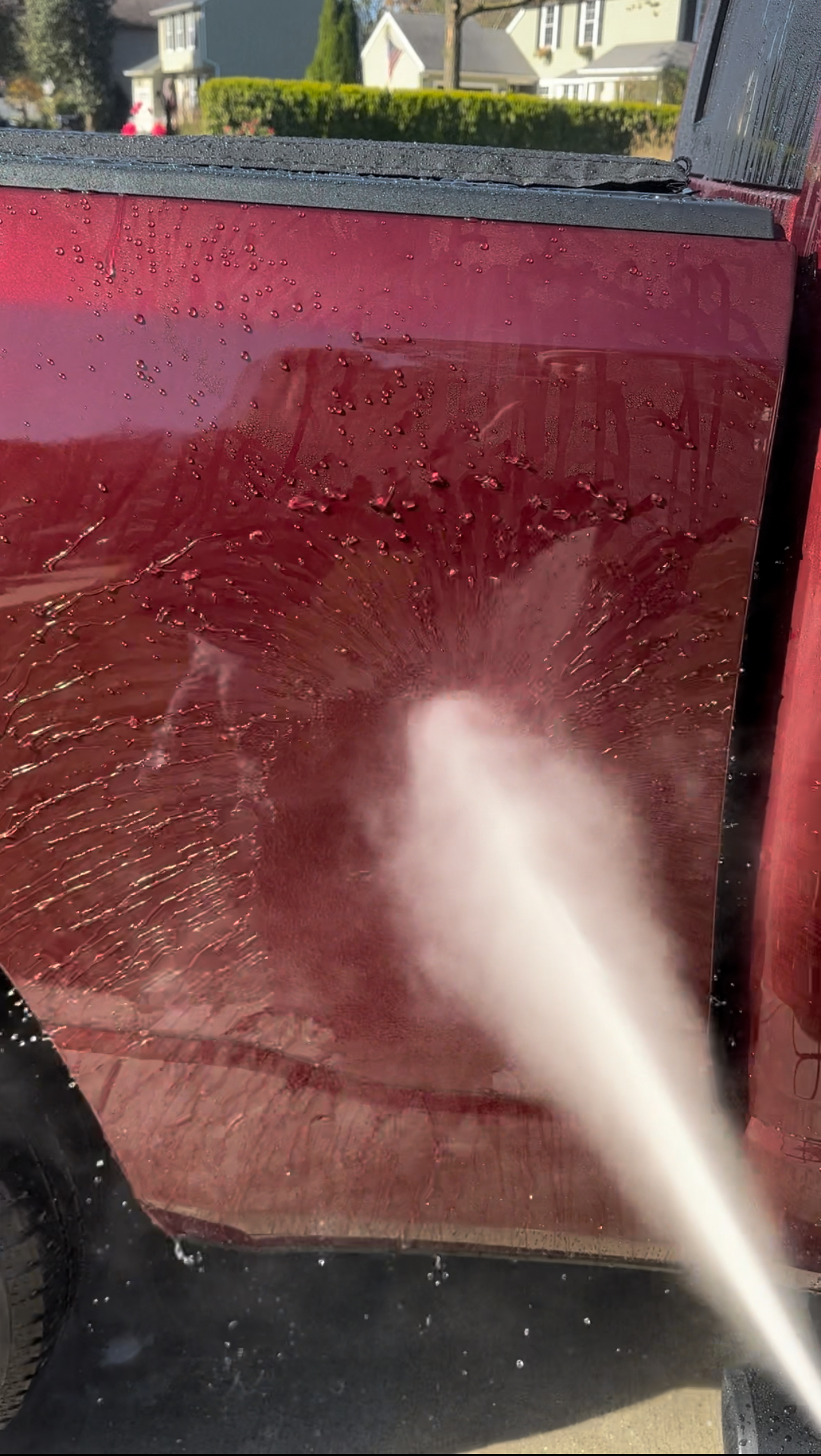 a person wearing gloves is cleaning a black surface with a white cloth