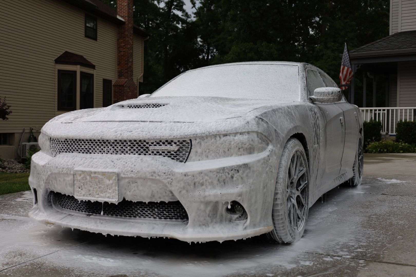 a car with a new jersey license plate is covered in foam