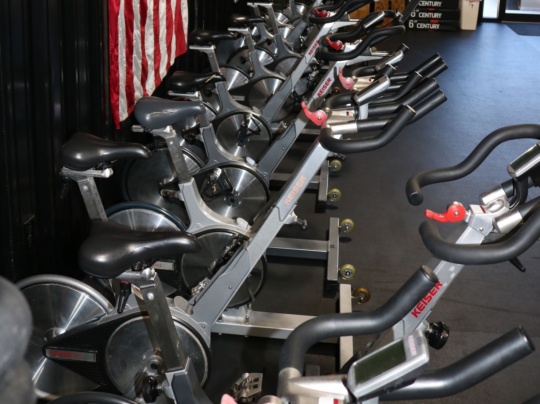 A group of people are riding exercise bikes in a gym