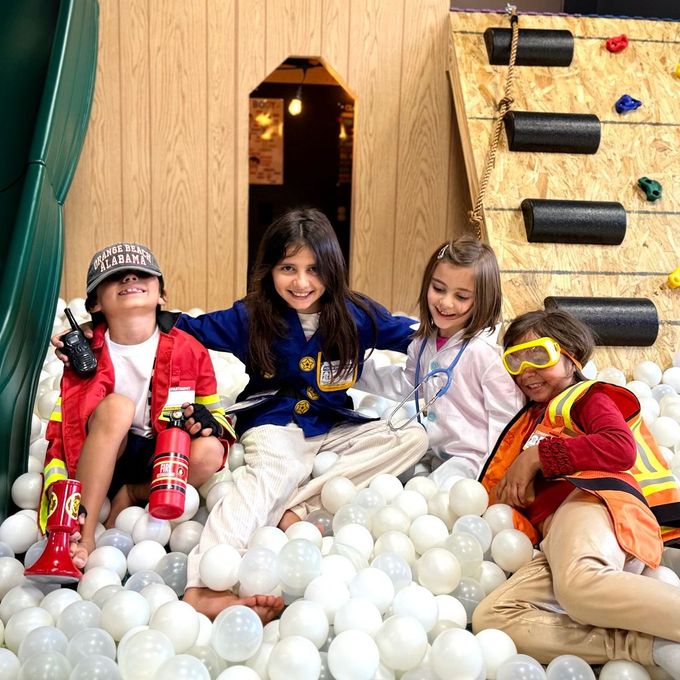 A group of children are playing in a ball pit.