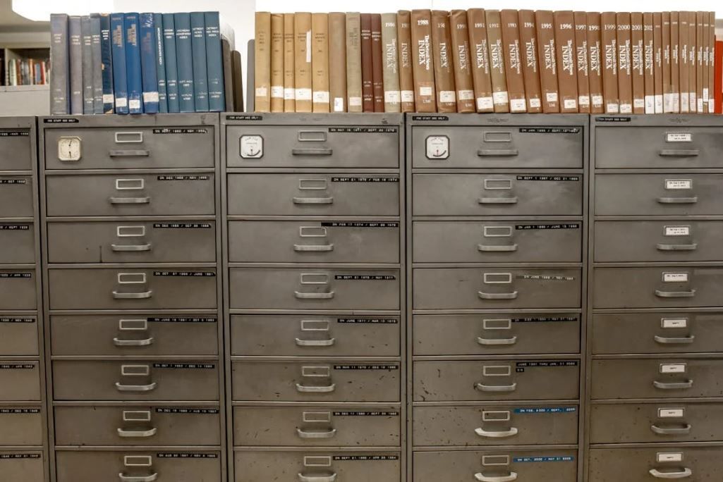 A row of filing cabinets filled with books including one that says ' a ' on it