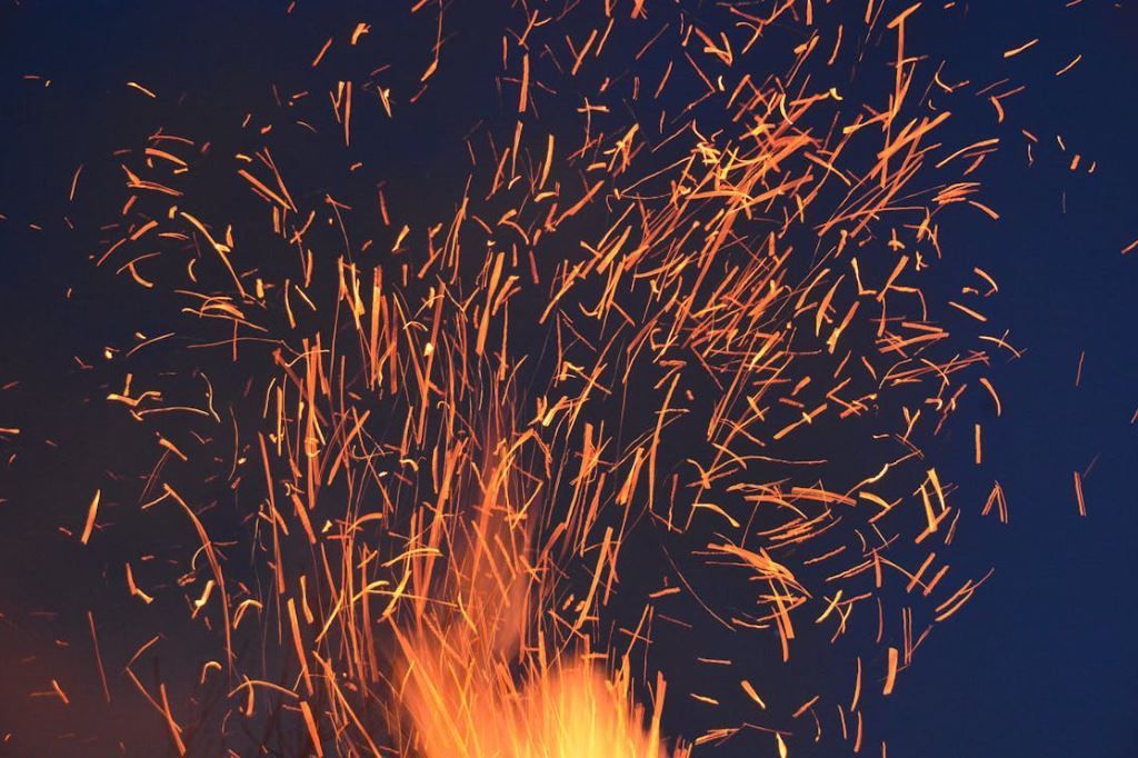 A close up of a fire with sparks coming out of it