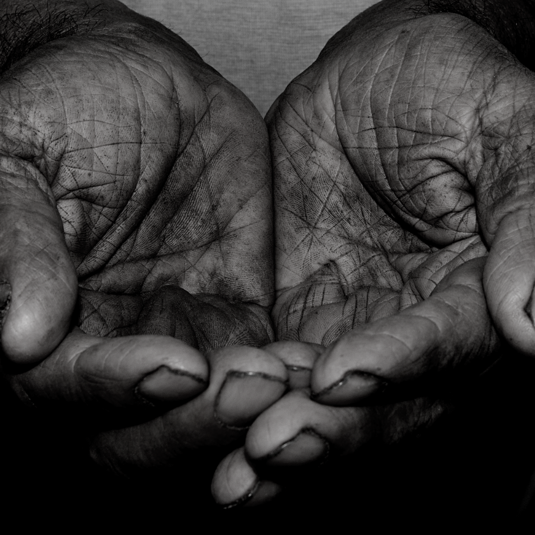 A black and white photo of a person 's hands holding something.