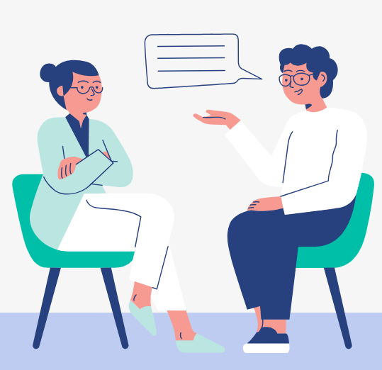 Woman in pajamas, using a phone, sitting in a small room. The room has a fridge, TV, and window.