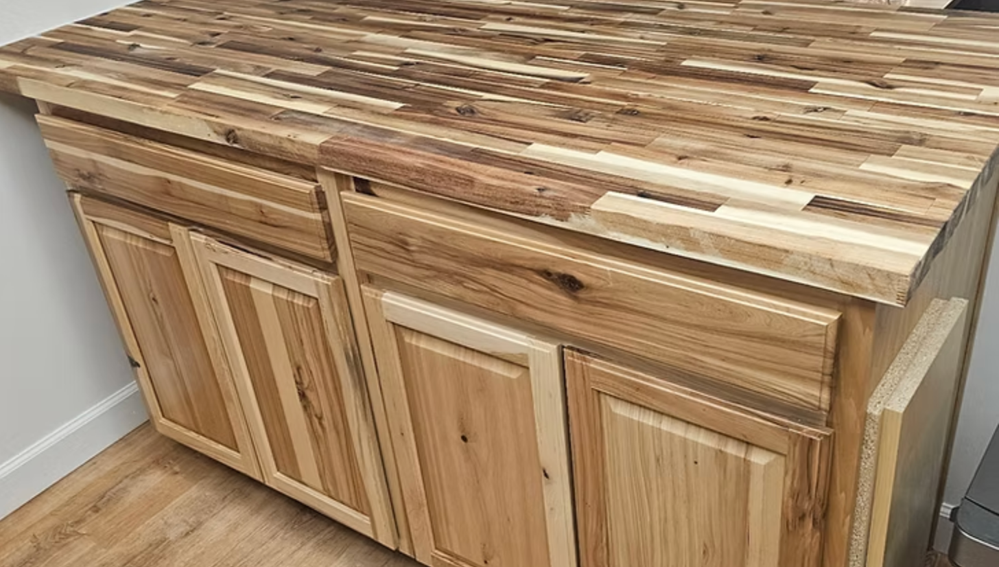 Wooden cabinet with matching countertop in a room.