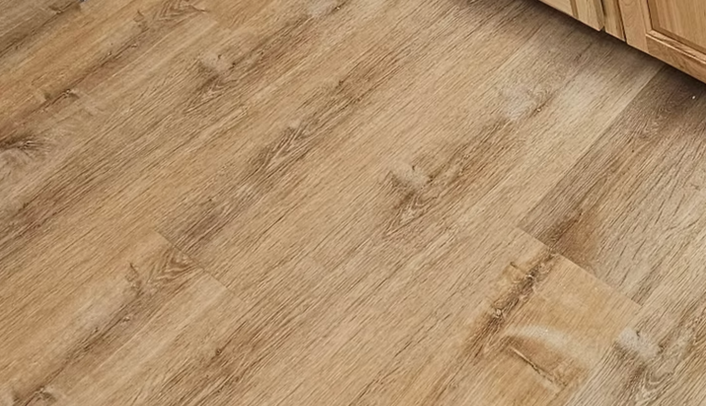 Light brown wood flooring with visible grain and texture.