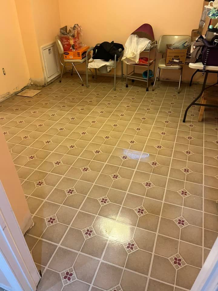A room with a tiled floor and chairs in it.