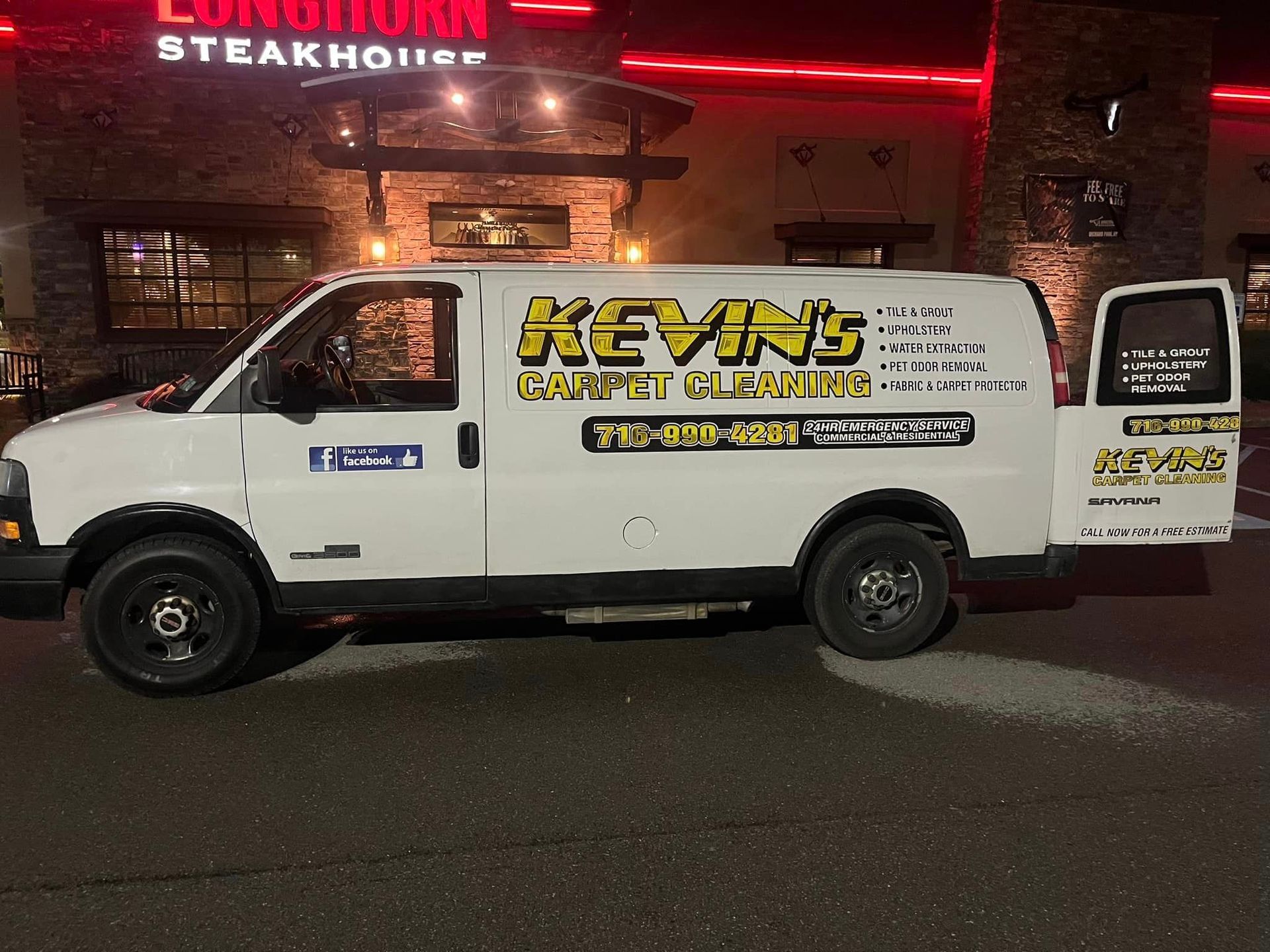 A kevin 's carpet cleaning van is parked in front of a restaurant