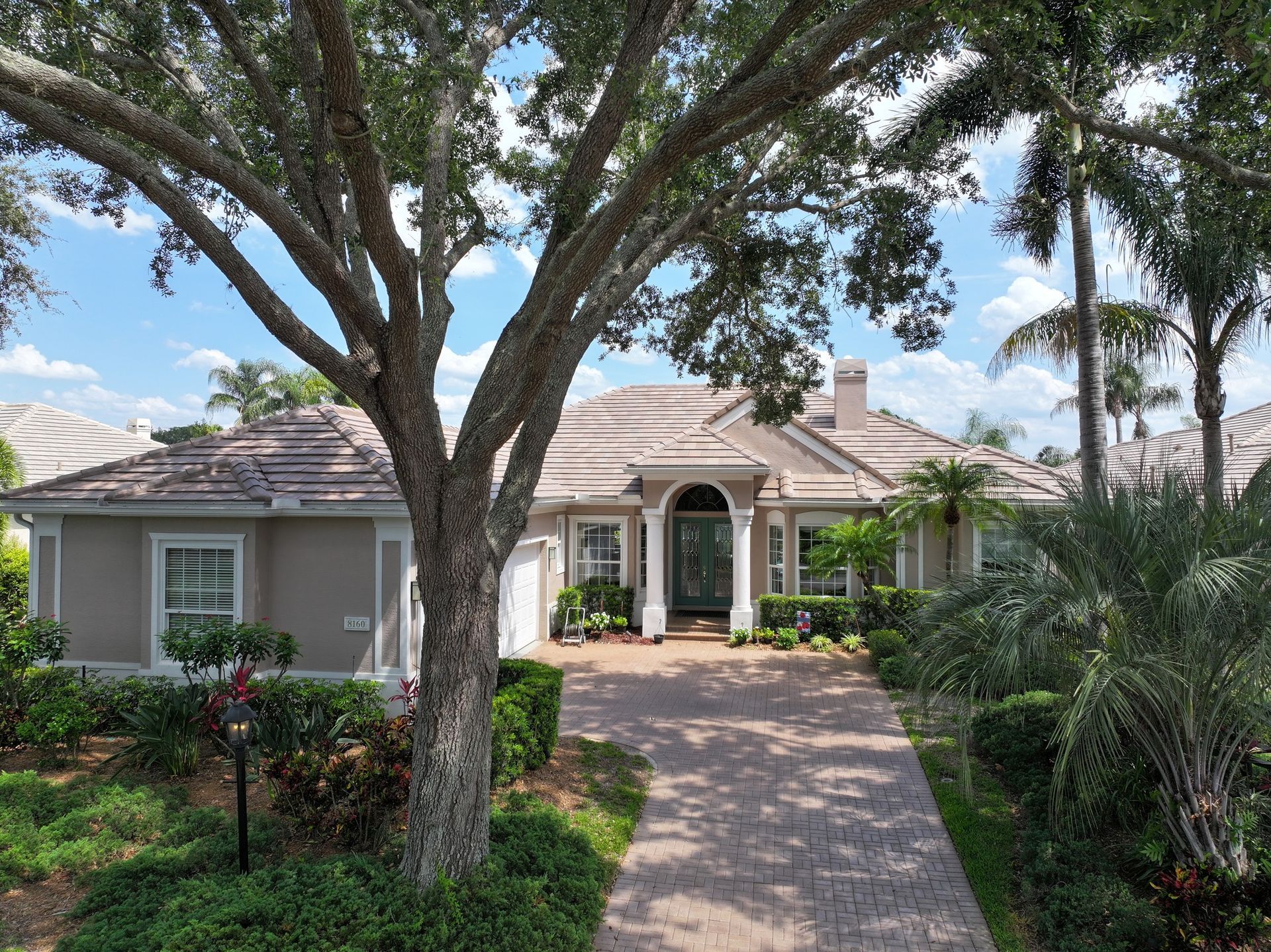A large house with a tree in front of it
