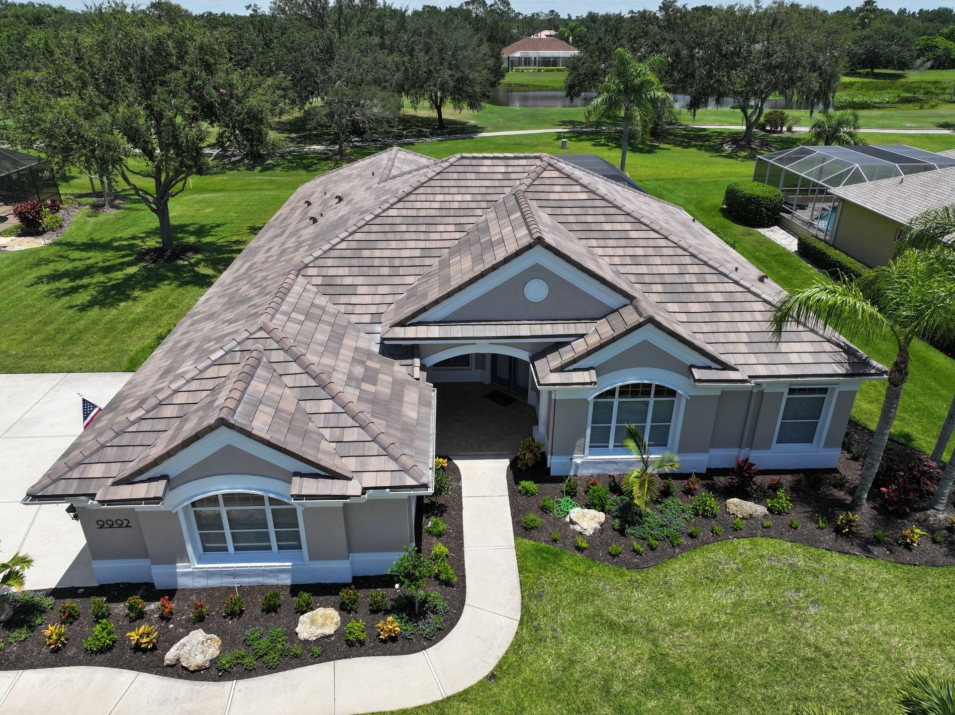An aerial view of a house with a tile roof