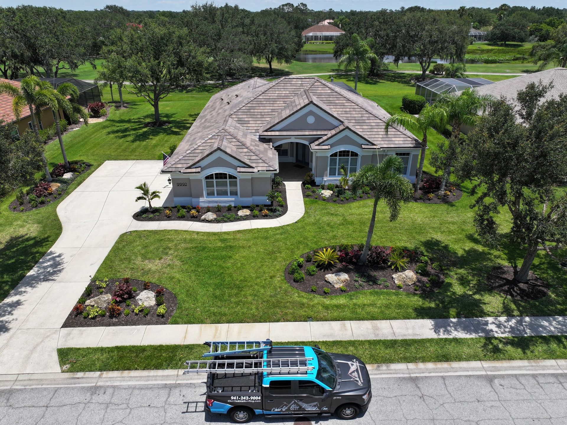 An aerial view of a house with a truck parked in front of it.