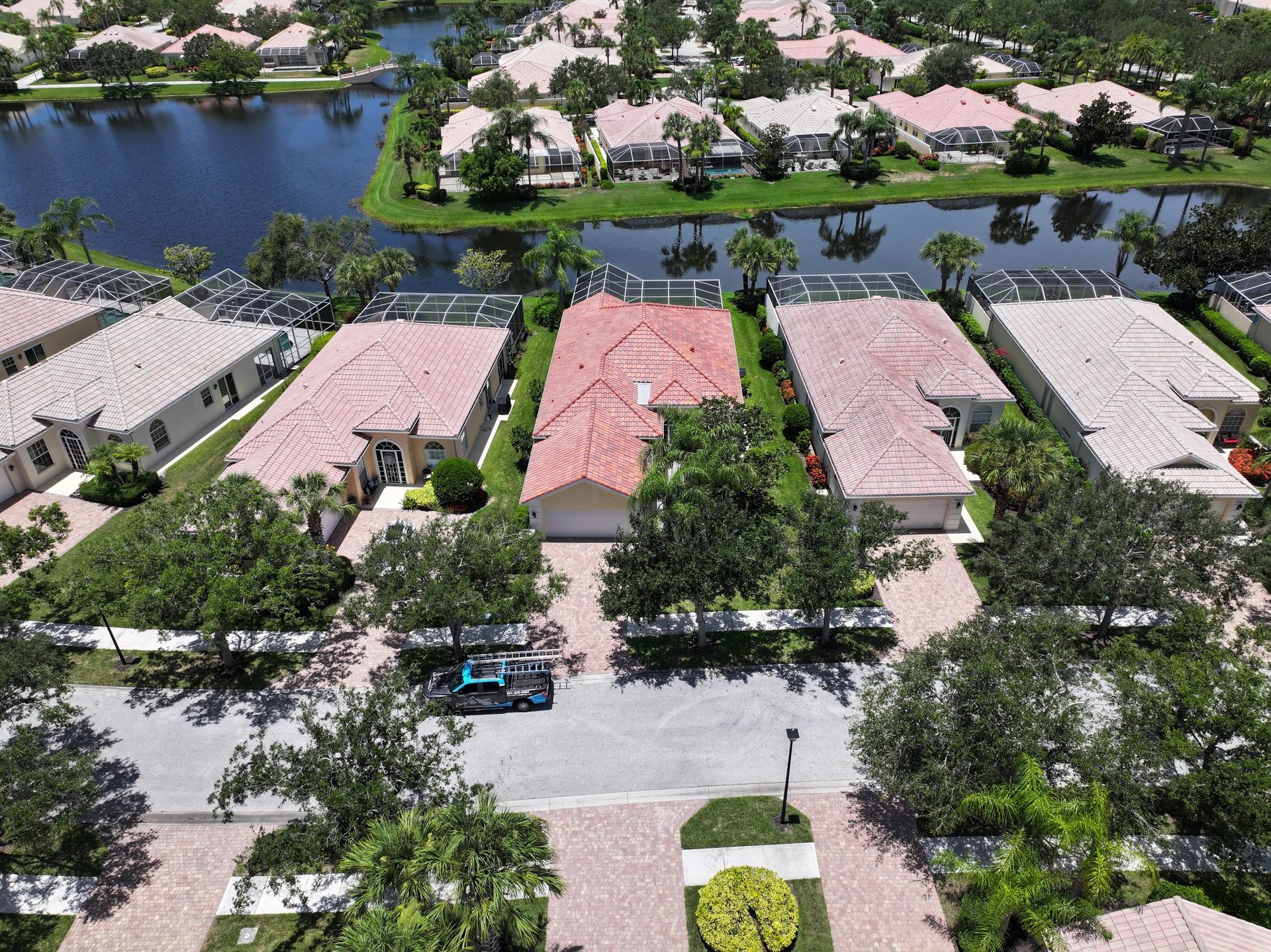 An aerial view of a residential area with a lake in the background