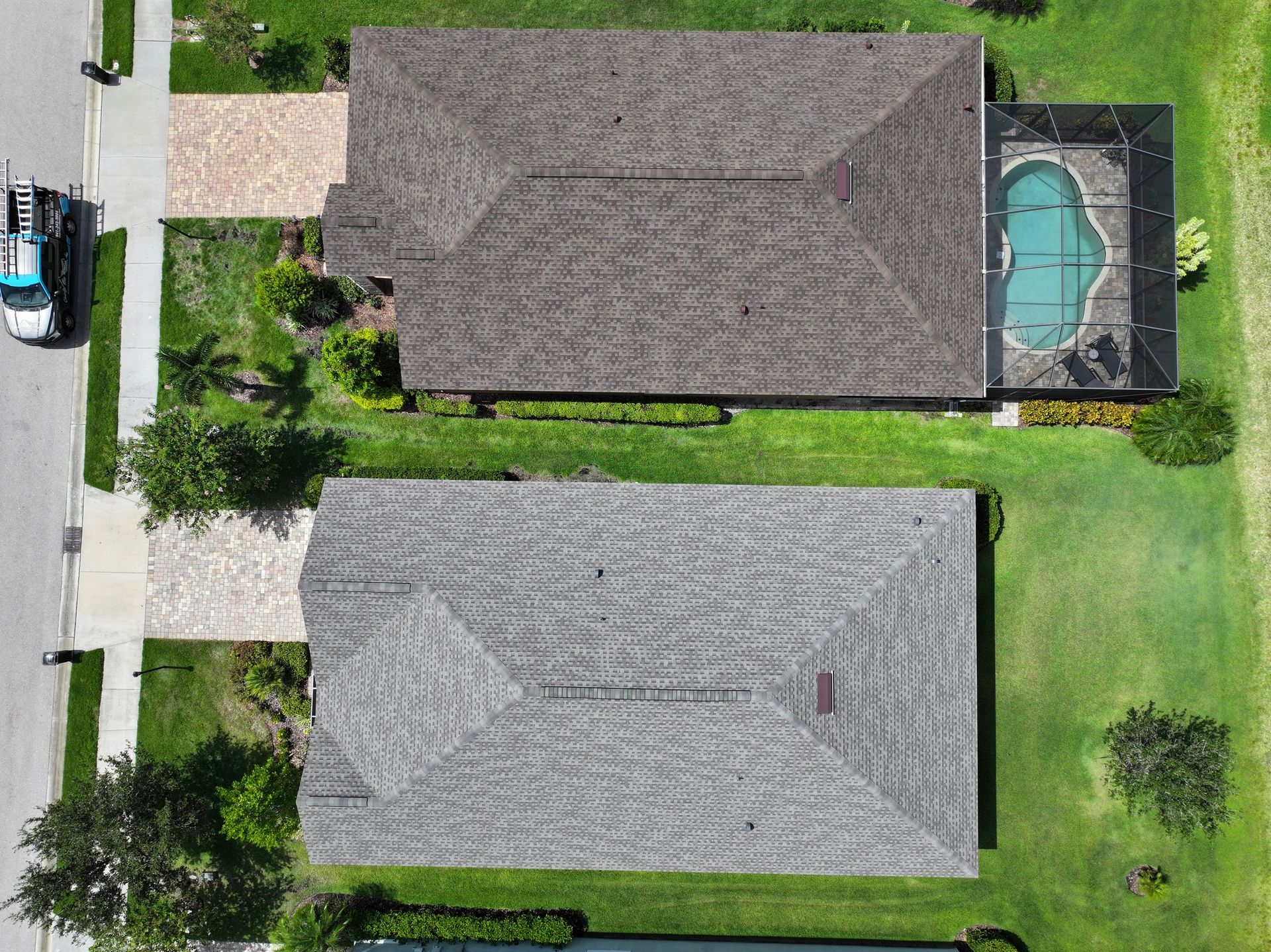 An aerial view of a house with a pool in the backyard