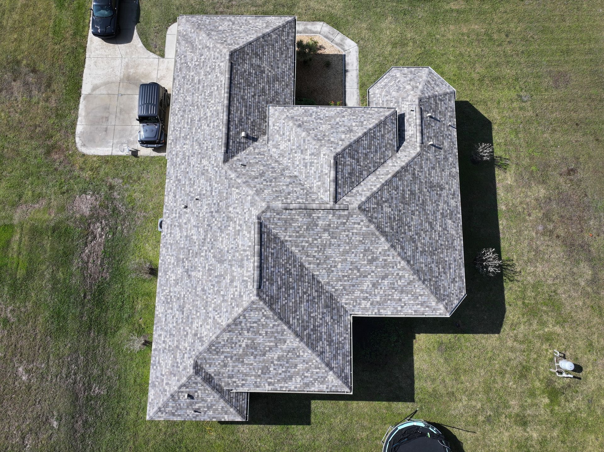 An aerial view of a house with a car parked in front of it.