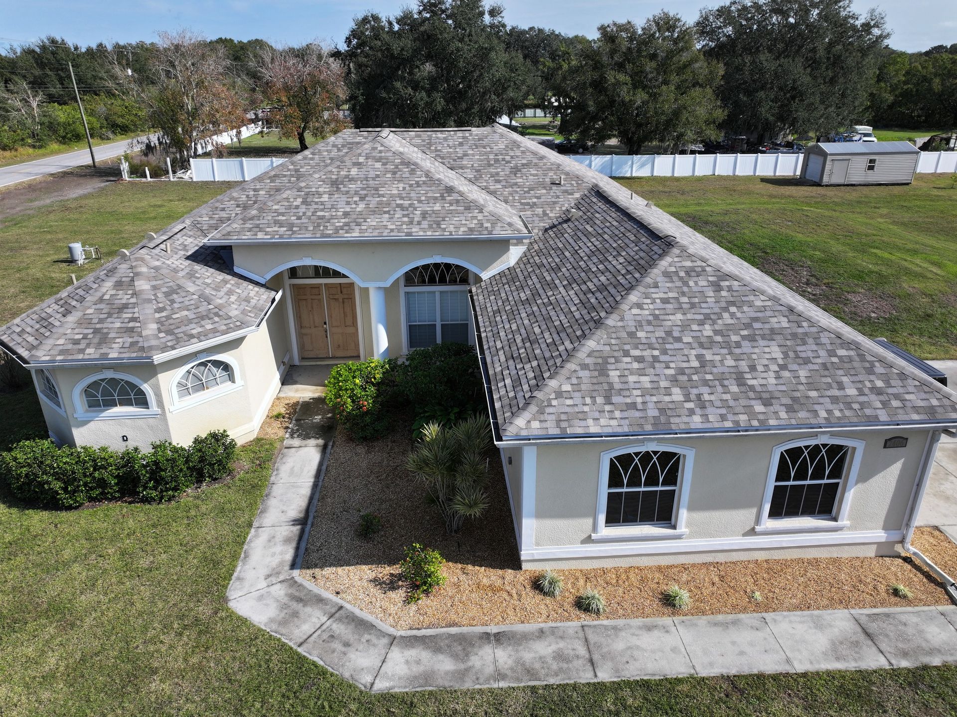 An aerial view of a house with a gray roof.