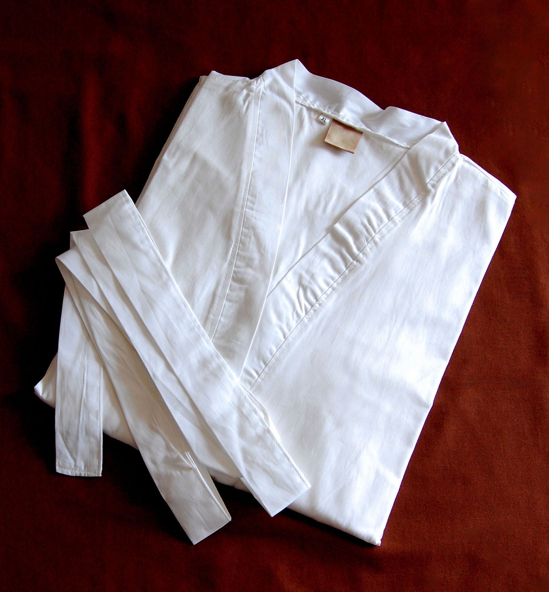 A white robe is folded up on a red cloth