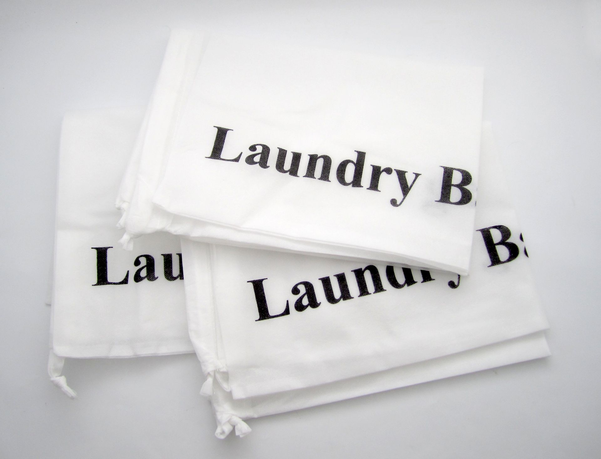A white laundry bag with laundry b written on it
