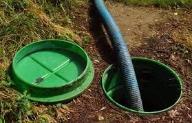 Two Aperol spritzes with orange slices and straws on a wooden table.