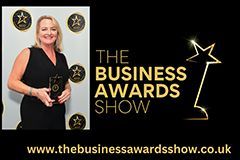A woman is holding a trophy at the business awards show.