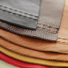 Natural leather upholstery samples with stitching in various colours