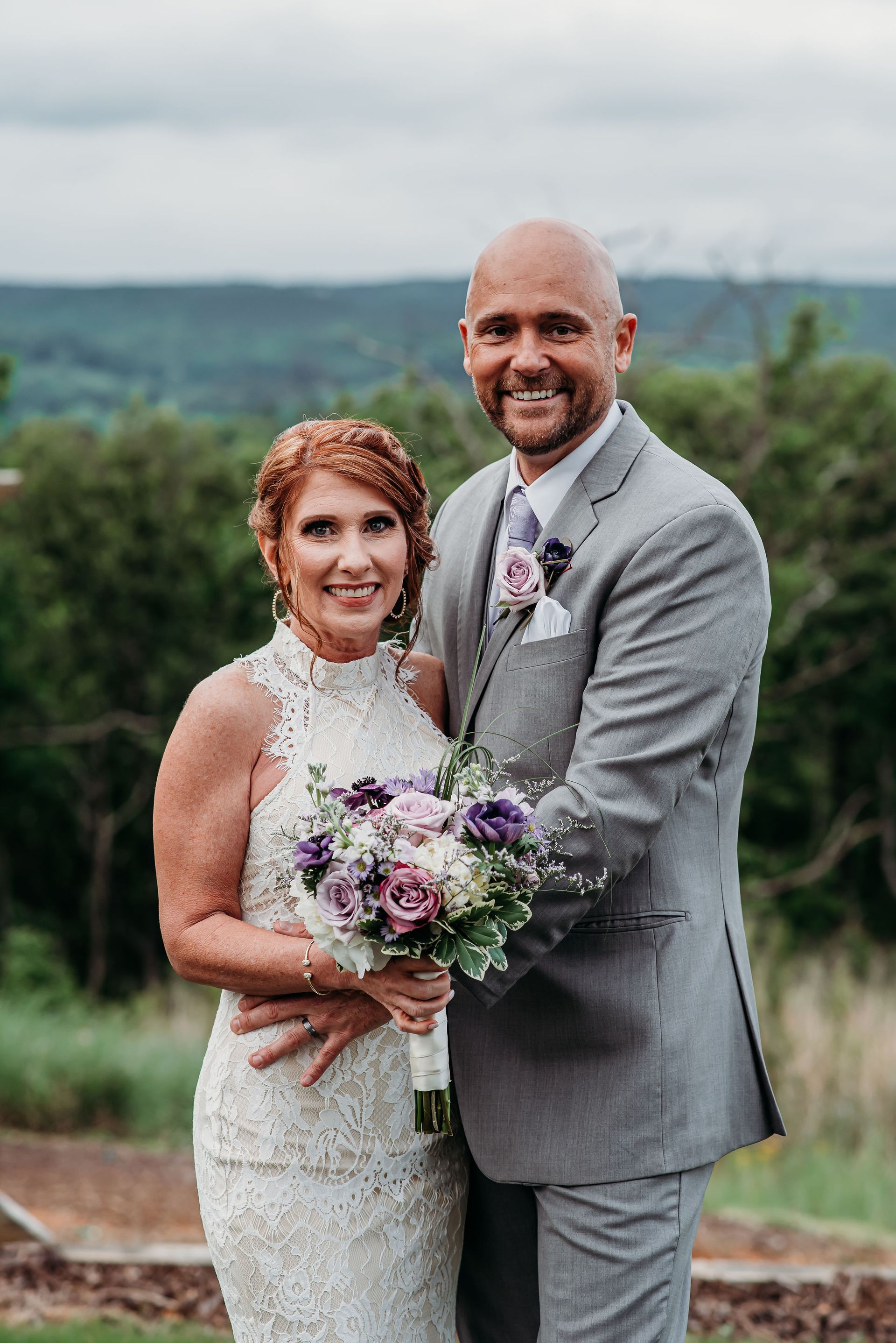 A bride and groom are posing for a picture on their wedding day.