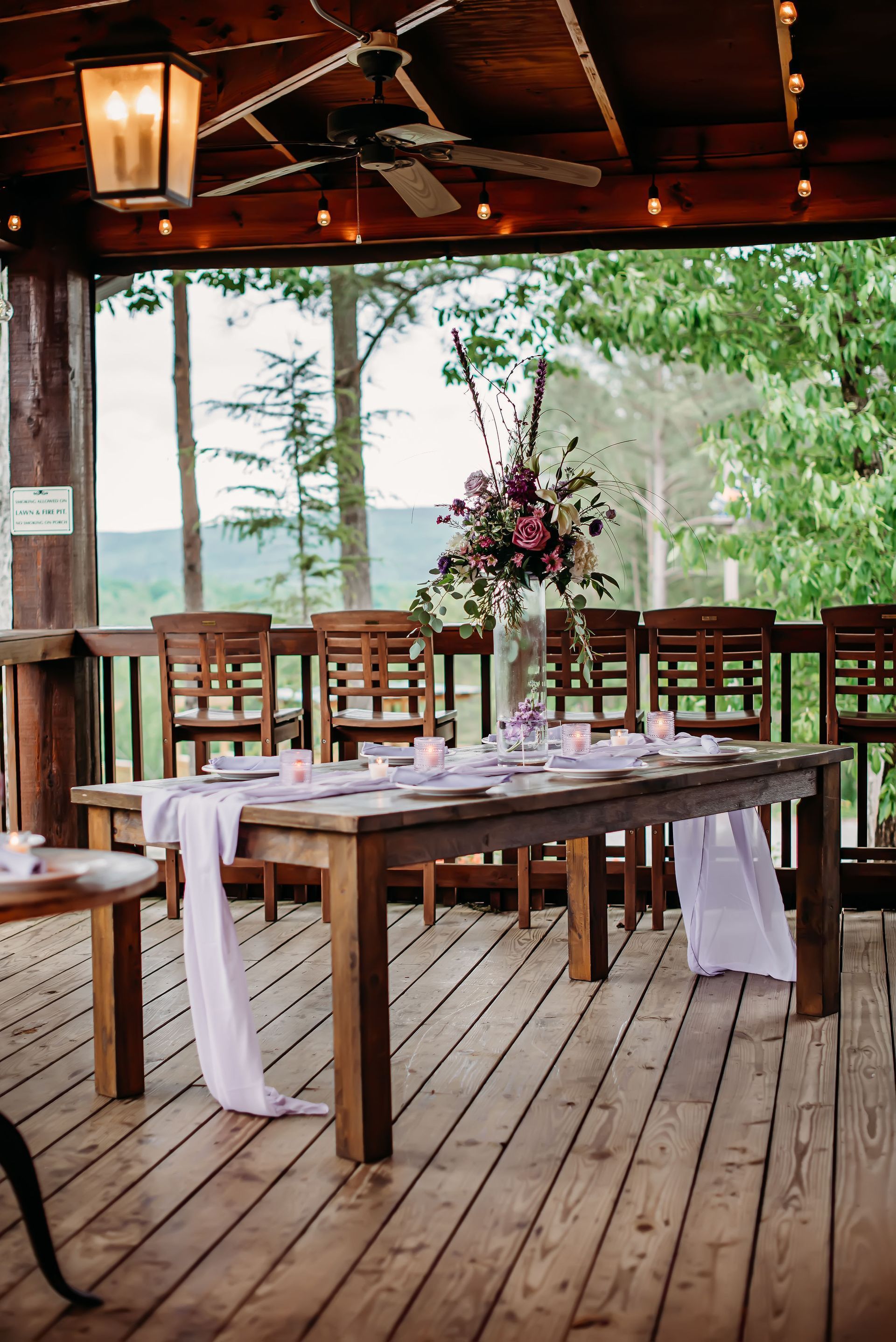 A wooden table is sitting on top of a wooden deck.