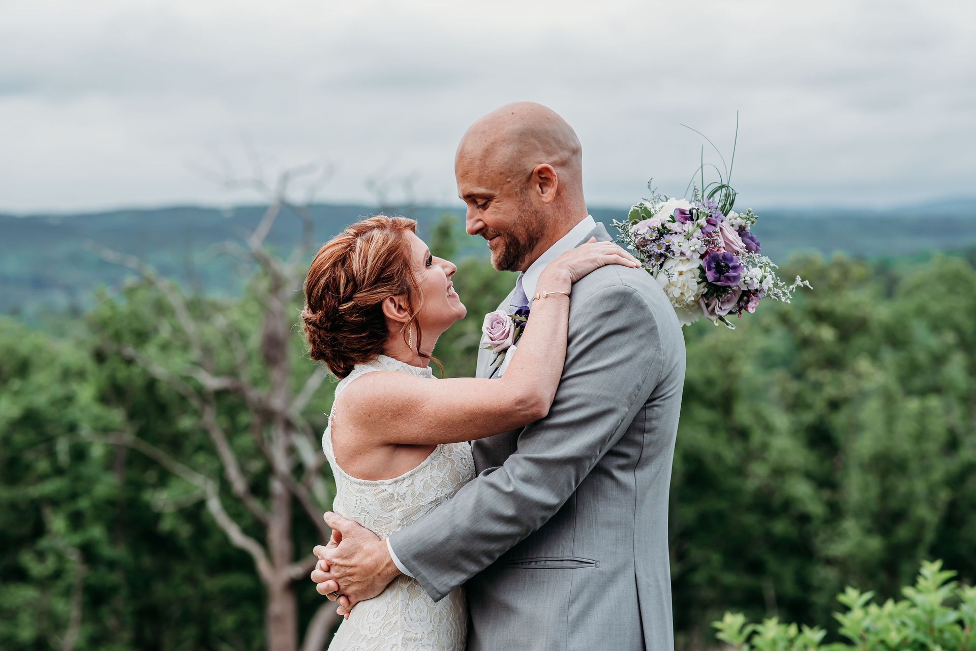 A bride and groom are posing for a picture on their wedding day.