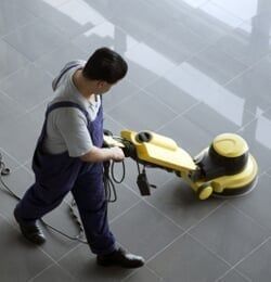 Man cleaning the floor with vacum cleaner