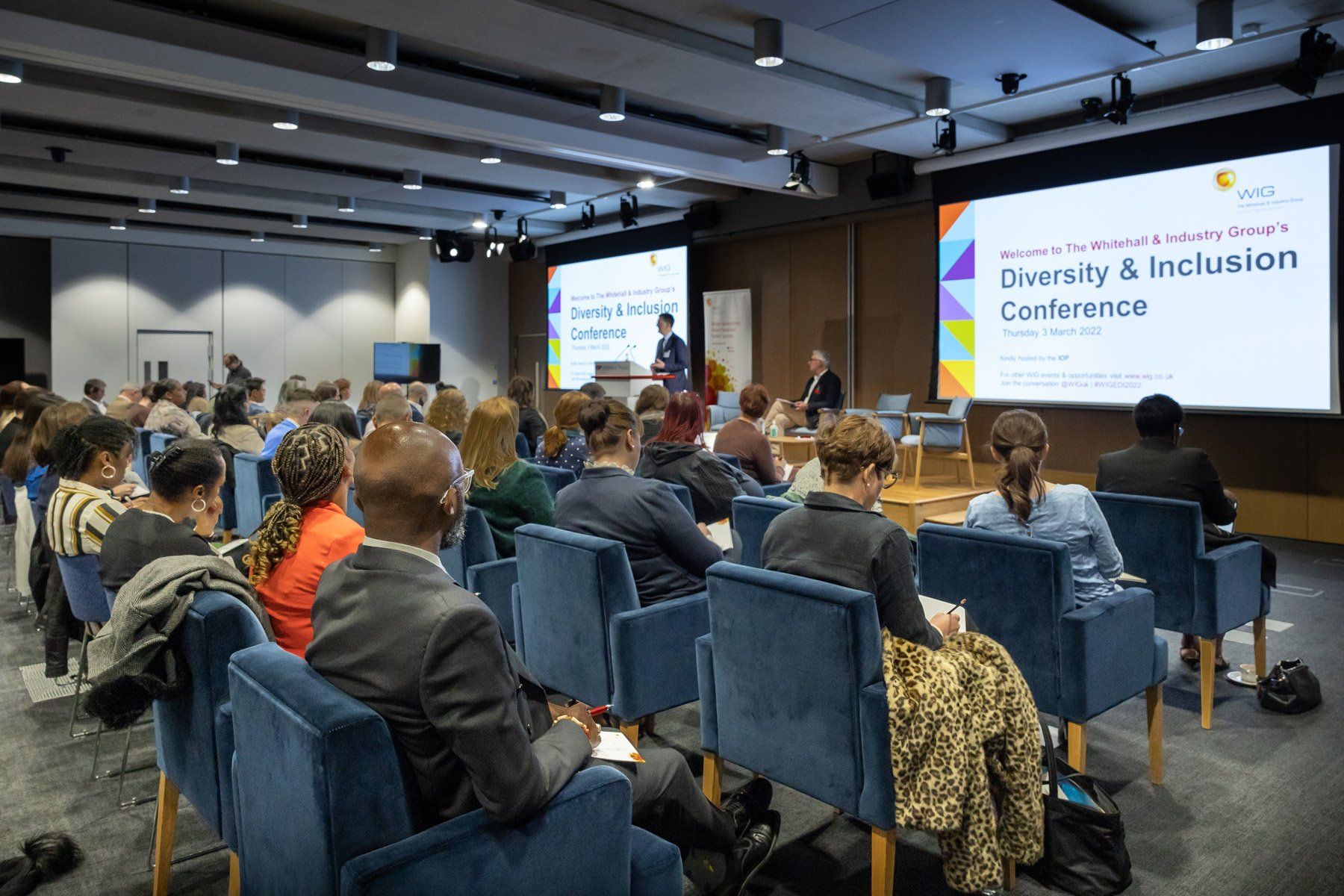 event photography reading, delegates listening to speaker at conference