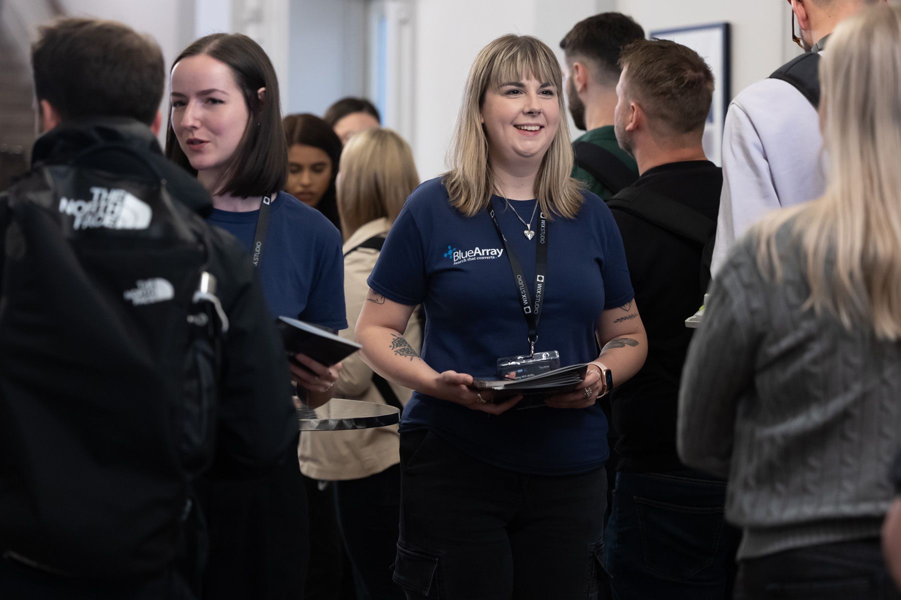 event photographer berkshire, female handing out leaflets at entrance of event