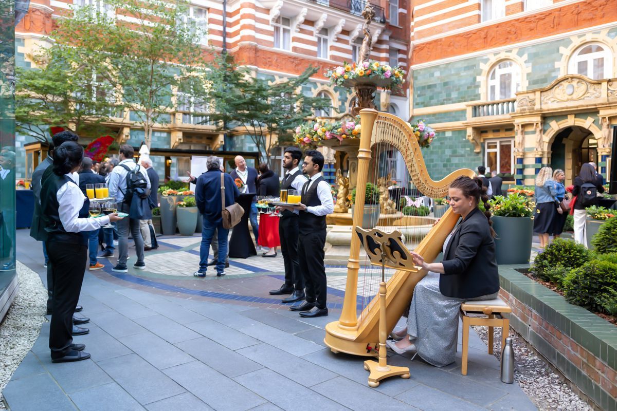 Event photography Berkshire, harpist playing at summer corporate reception