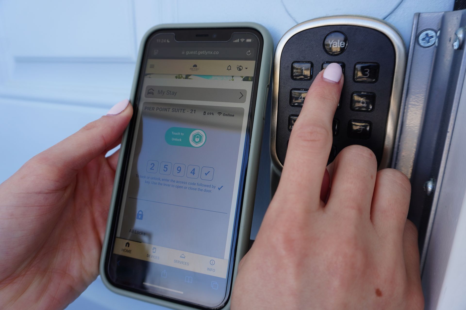 A person is using a smart phone to lock a garage door.